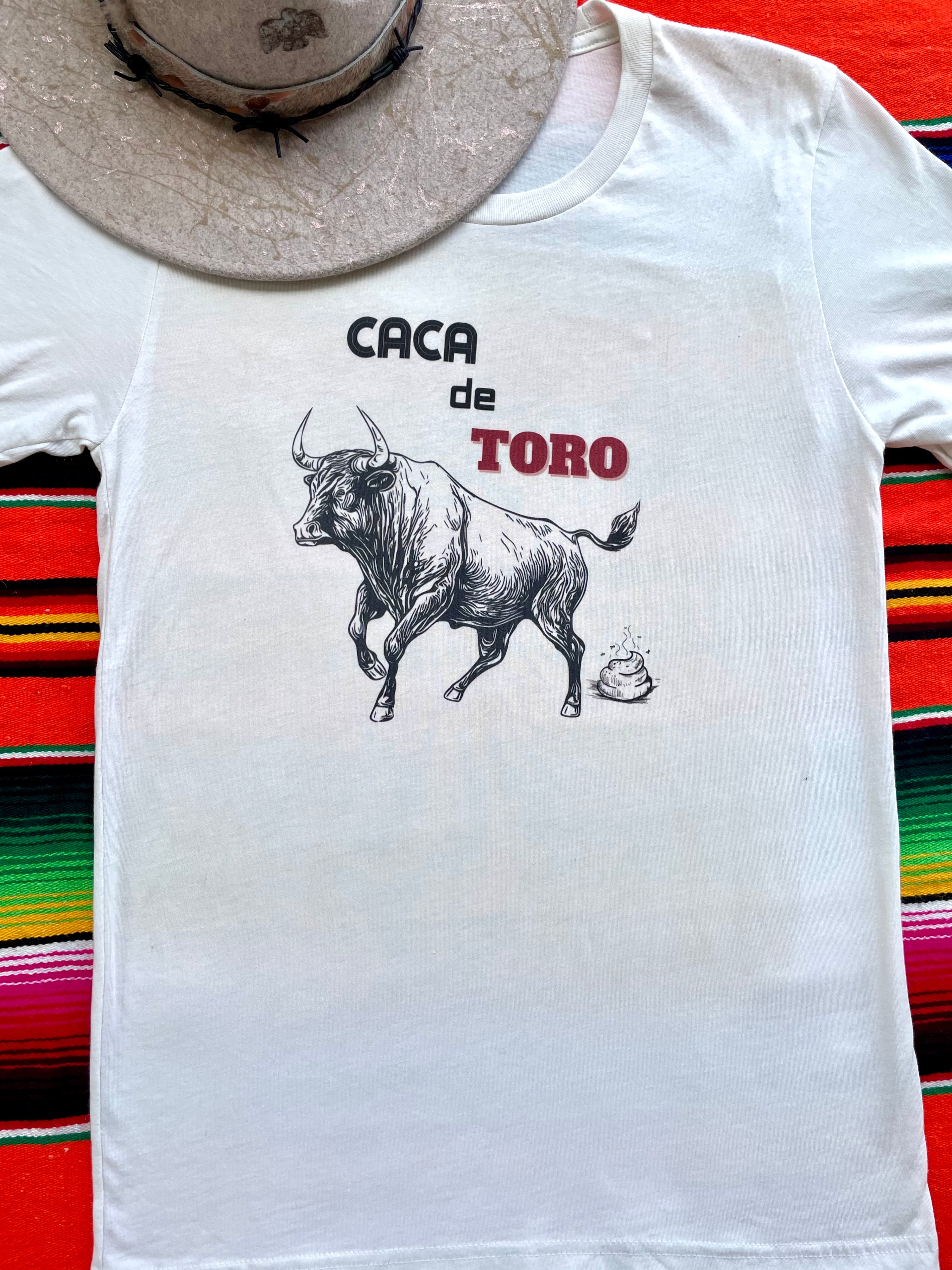 Antique White Bella+Canvas women’s graphic tee with western-inspired “CACA DE TORO” with bull AND LUMP OF SHIT Graphic 