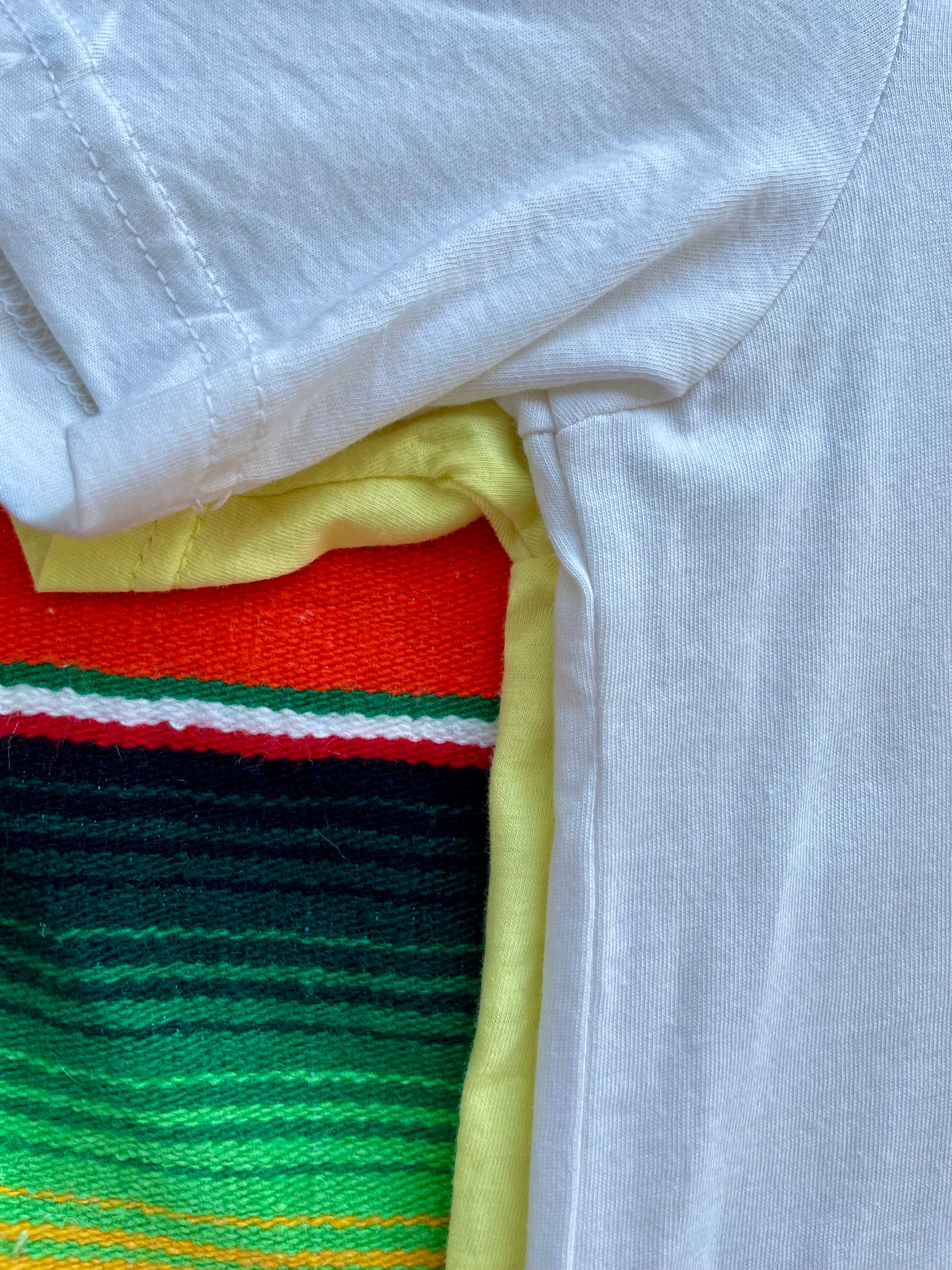 Close-up of a white shirt with colorful fabric underneath