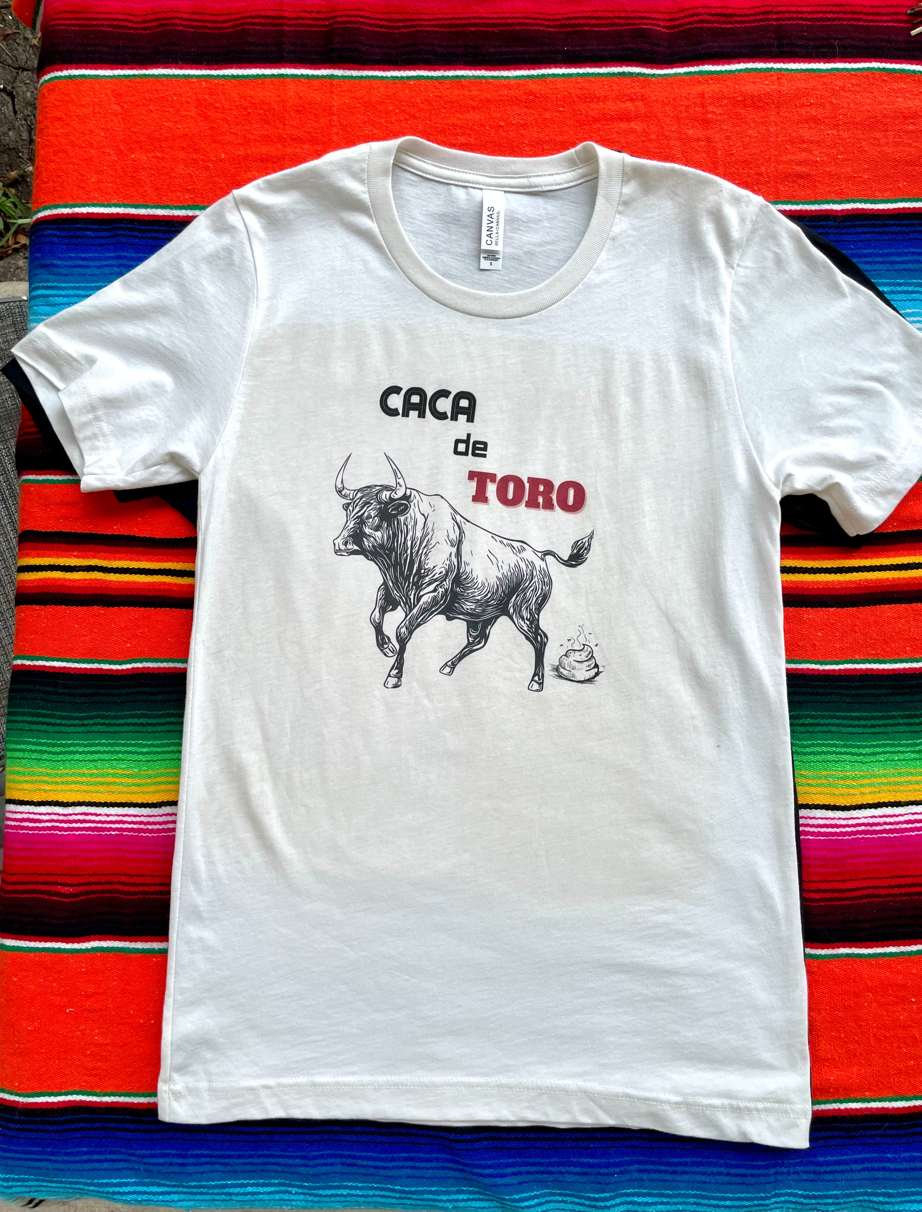 White t-shirt with bull graphic and text on a colorful striped background