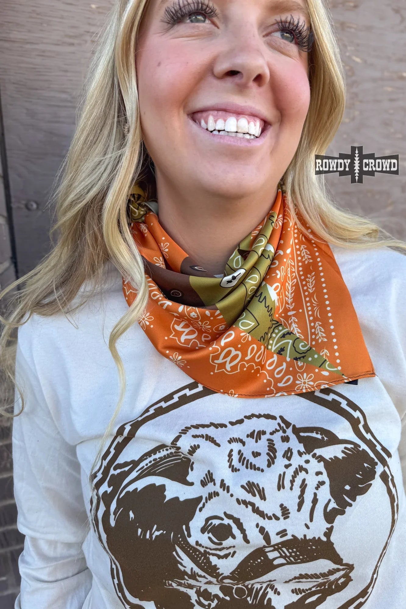 close up of small bandana patch wild rag polyester fabric with bold western print