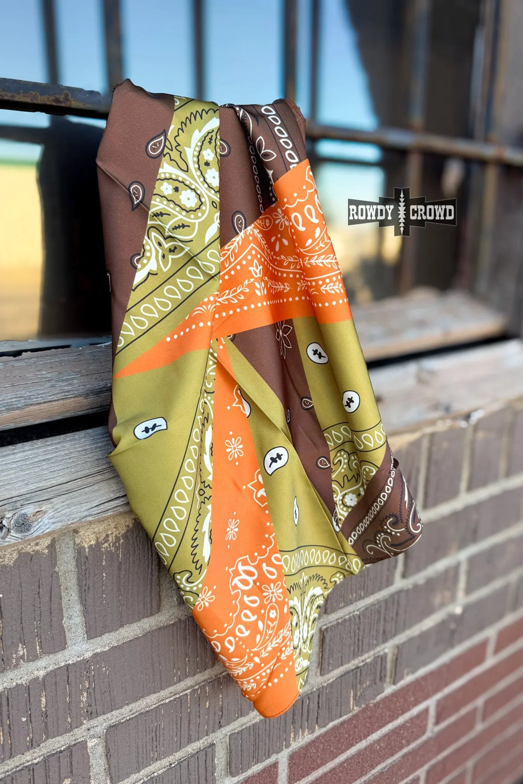 close up of small bandana patch wild rag polyester fabric with bold western print