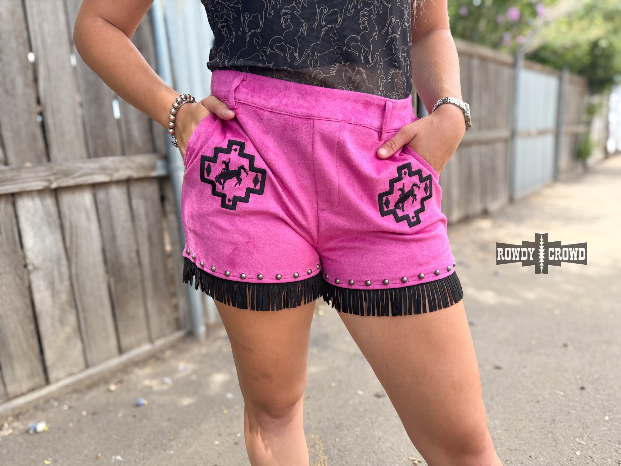 Rowdy Crowd  pink shorts with black fringe and geometric pattern with bronco and rider