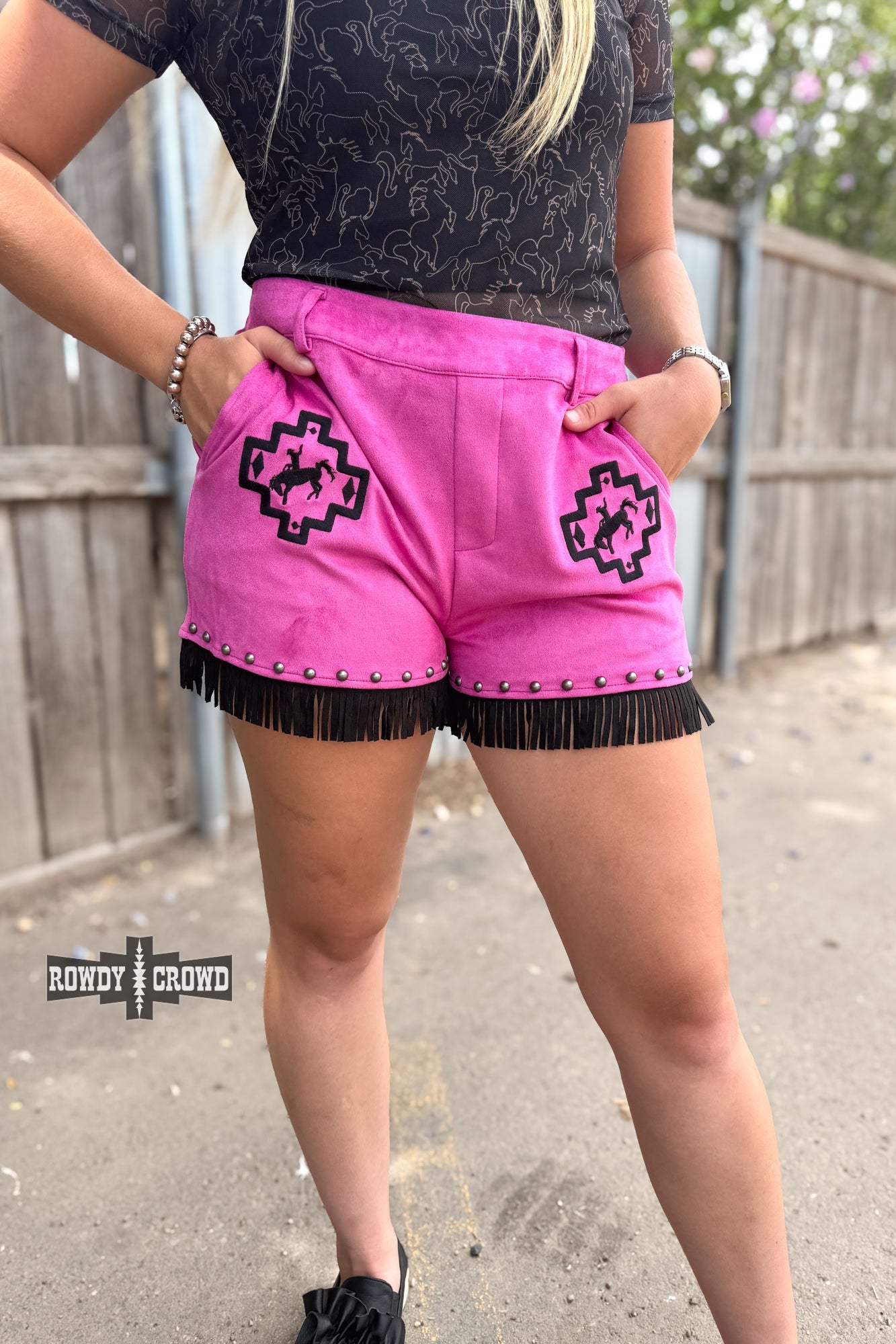 Rowdy Crowd  pink shorts with black fringe and geometric pattern with bronco and rider