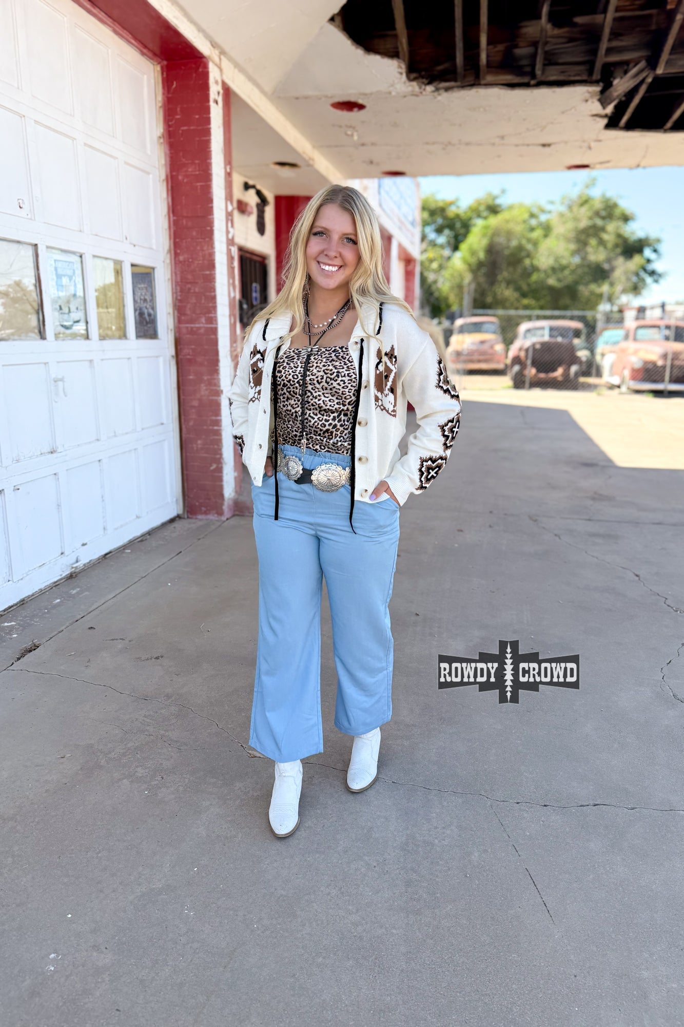 Woman standing in front of a building wearing Rowdy Crowd Ocean Breeze light blue Pants 