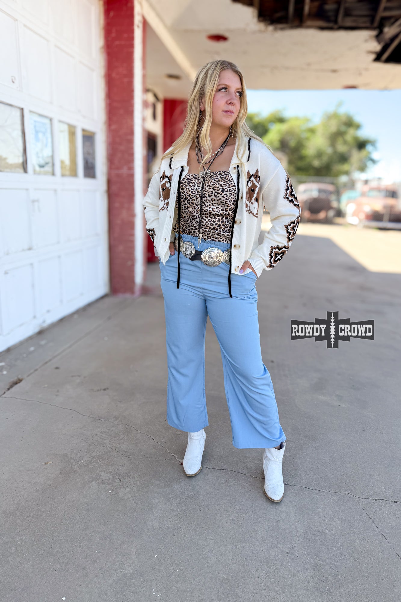 Woman standing in front of a building wearing Rowdy Crowd Ocean Breeze light blue Pants 