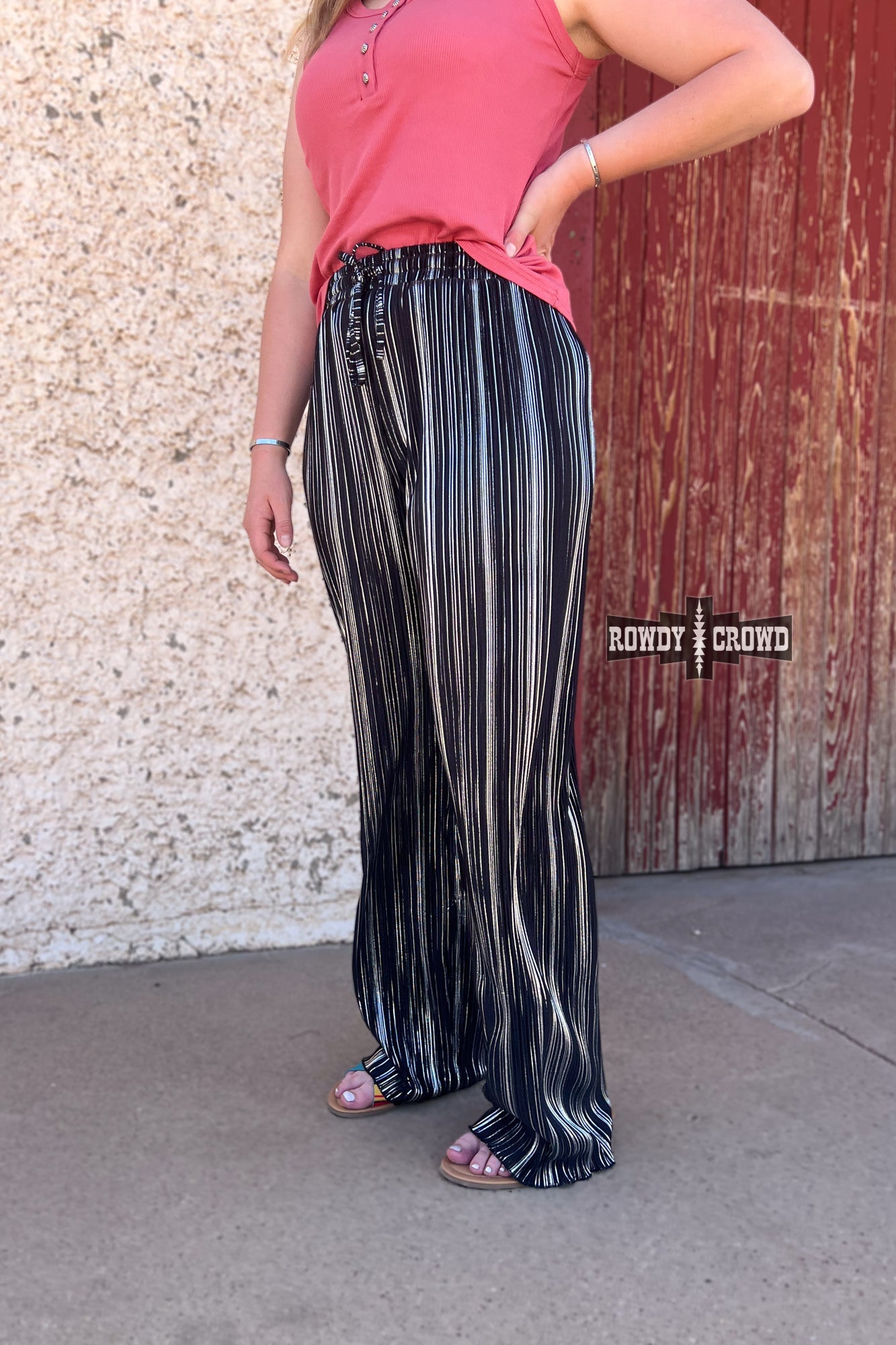 Person wearing a graphic t-shirt and Rowdy Crowd Ruffled Cup wide leg striped pants 
