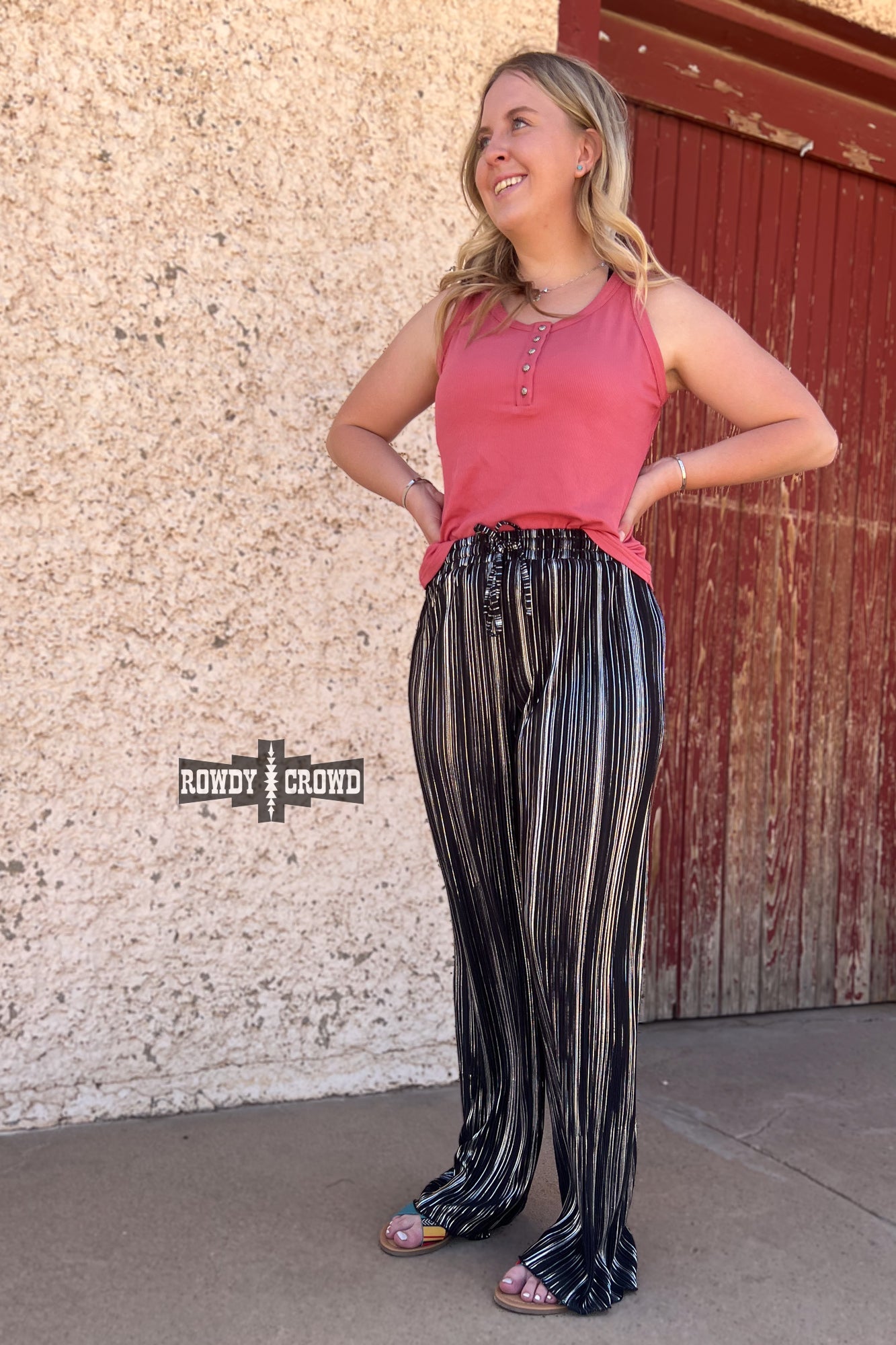 Person wearing a graphic t-shirt and Rowdy Crowd Ruffled Cup wide leg striped pants 