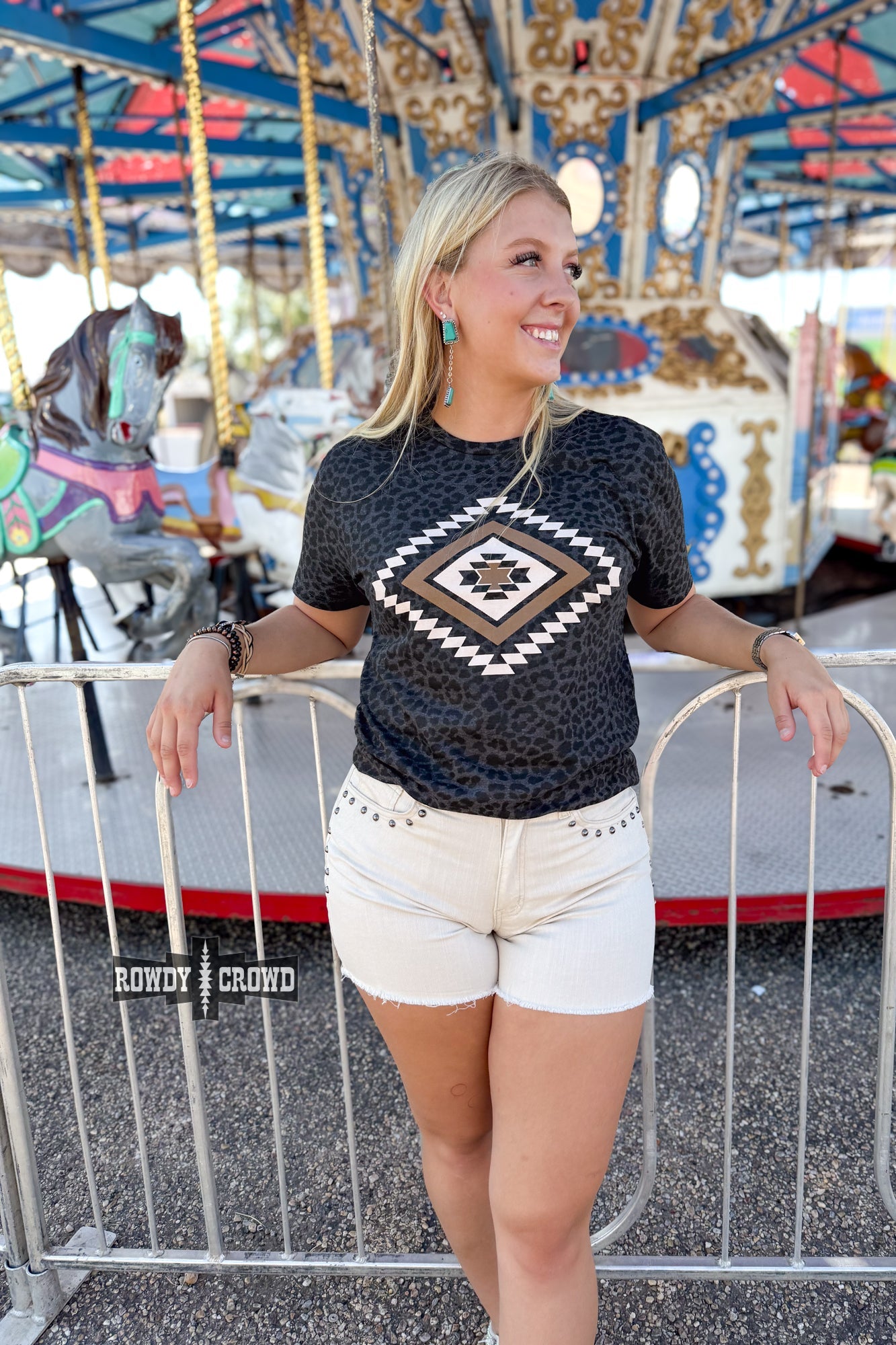 Rowdy Crowd Wild As You Graphic Tee bold Aztec diamond design against a subtle black leopard print 