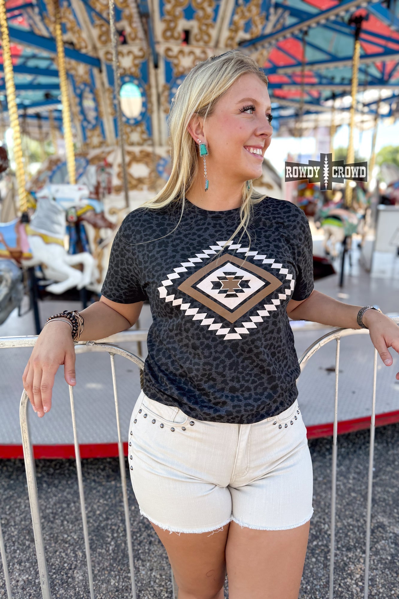 Rowdy Crowd Wild As You Graphic Tee bold Aztec diamond design against a subtle black leopard print 
