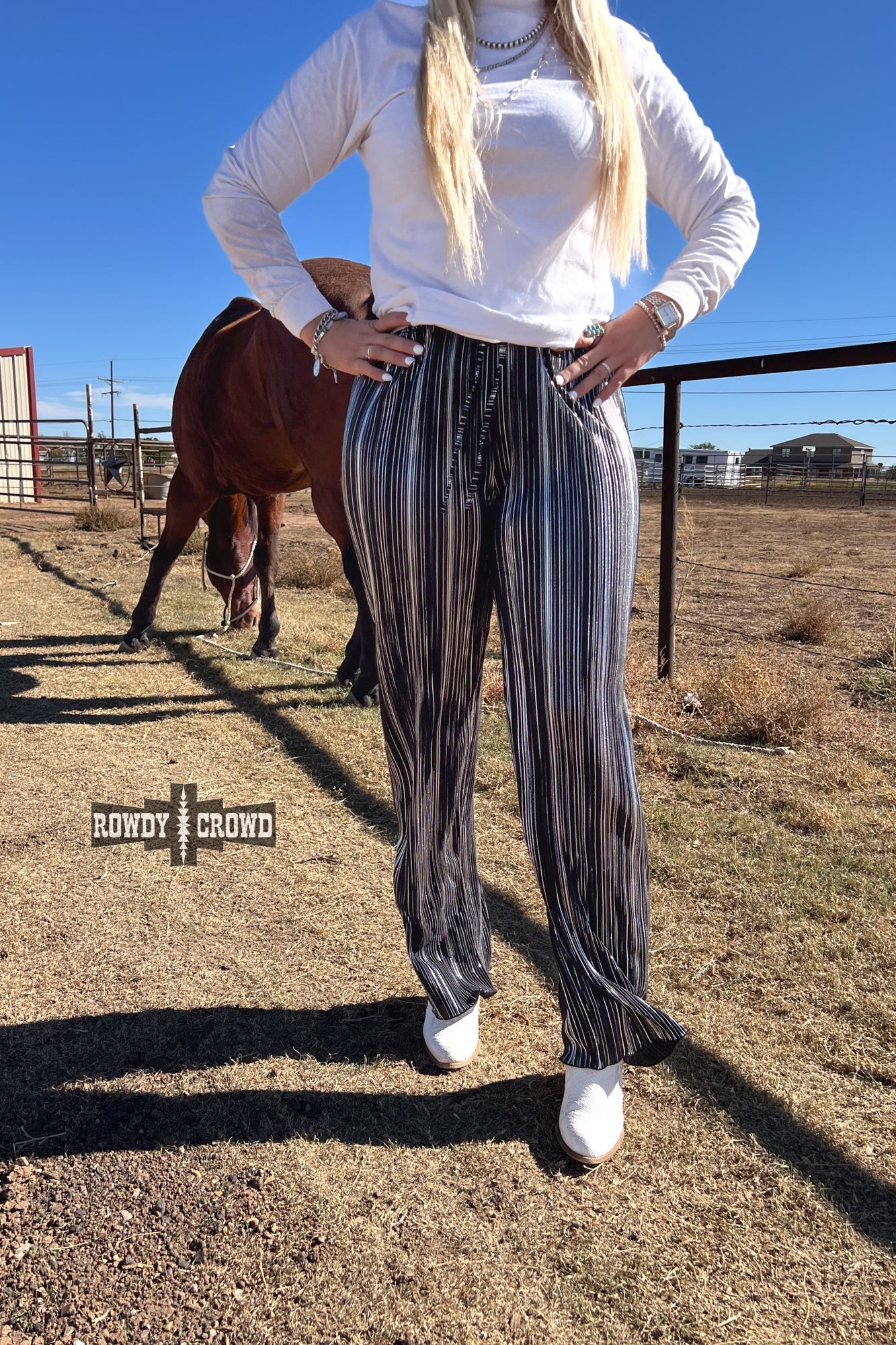 Person wearing a graphic t-shirt and Rowdy Crowd Ruffled Cup wide leg striped pants 