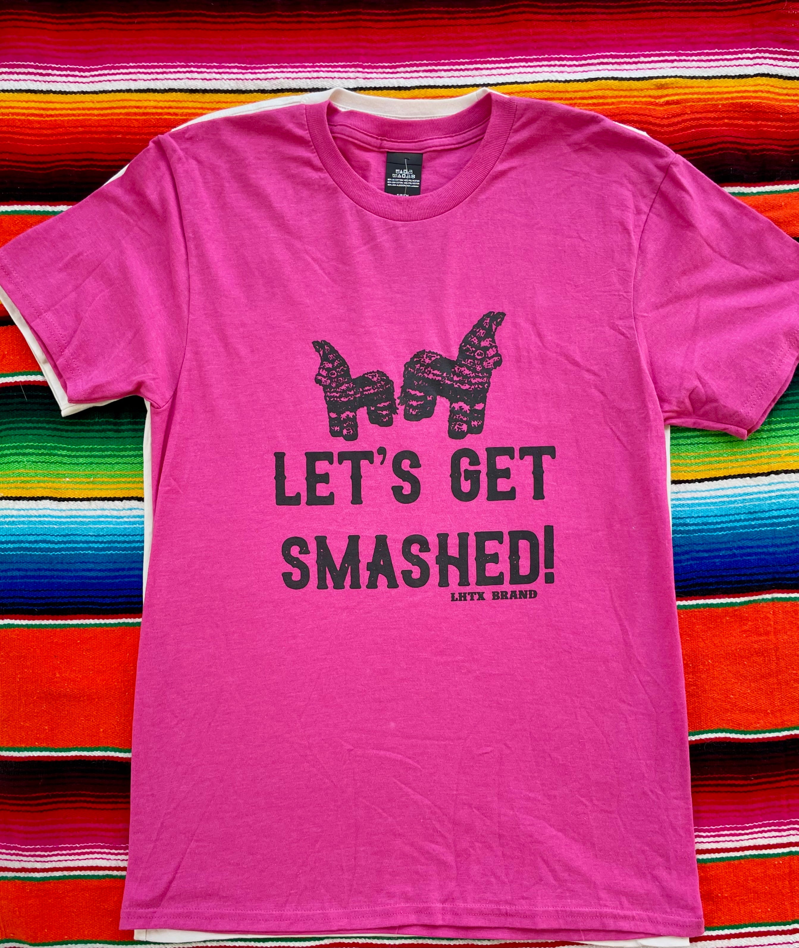 Pink t-shirt with 'Let's Get Smashed!' text on a colorful striped background