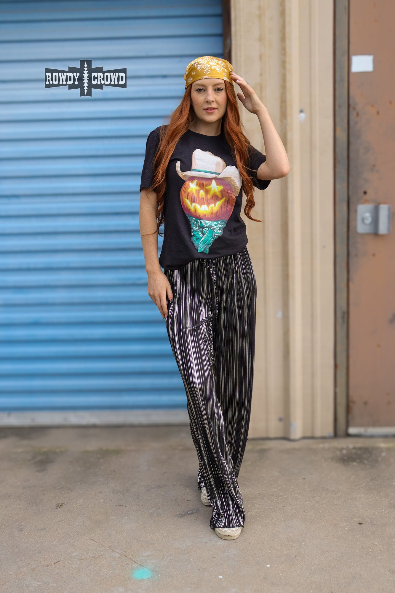 Person wearing a graphic t-shirt and Rowdy Crowd Ruffled Cup wide leg striped pants 