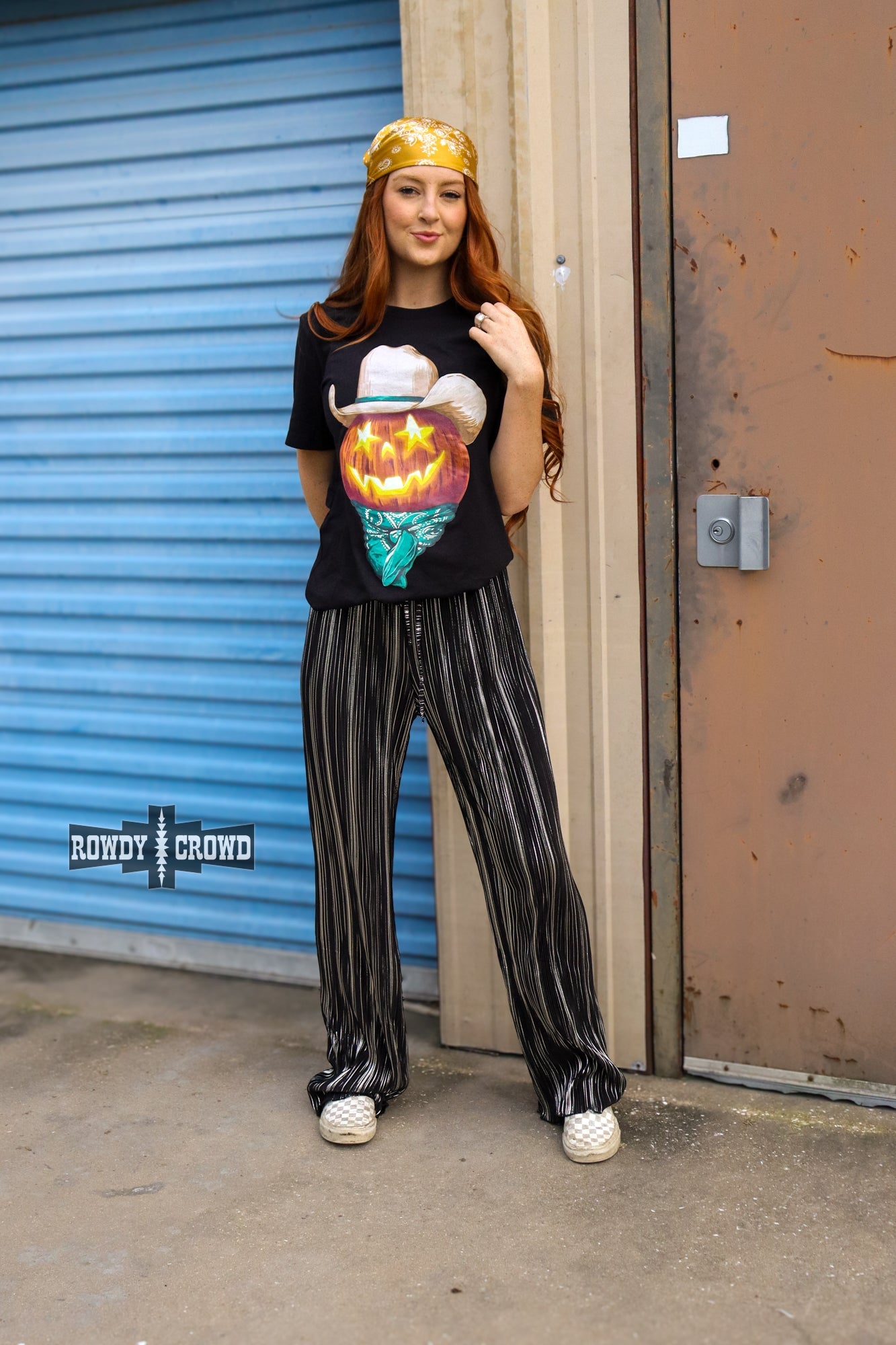 Person wearing a graphic t-shirt and Rowdy Crowd Ruffled Cup wide leg striped pants 