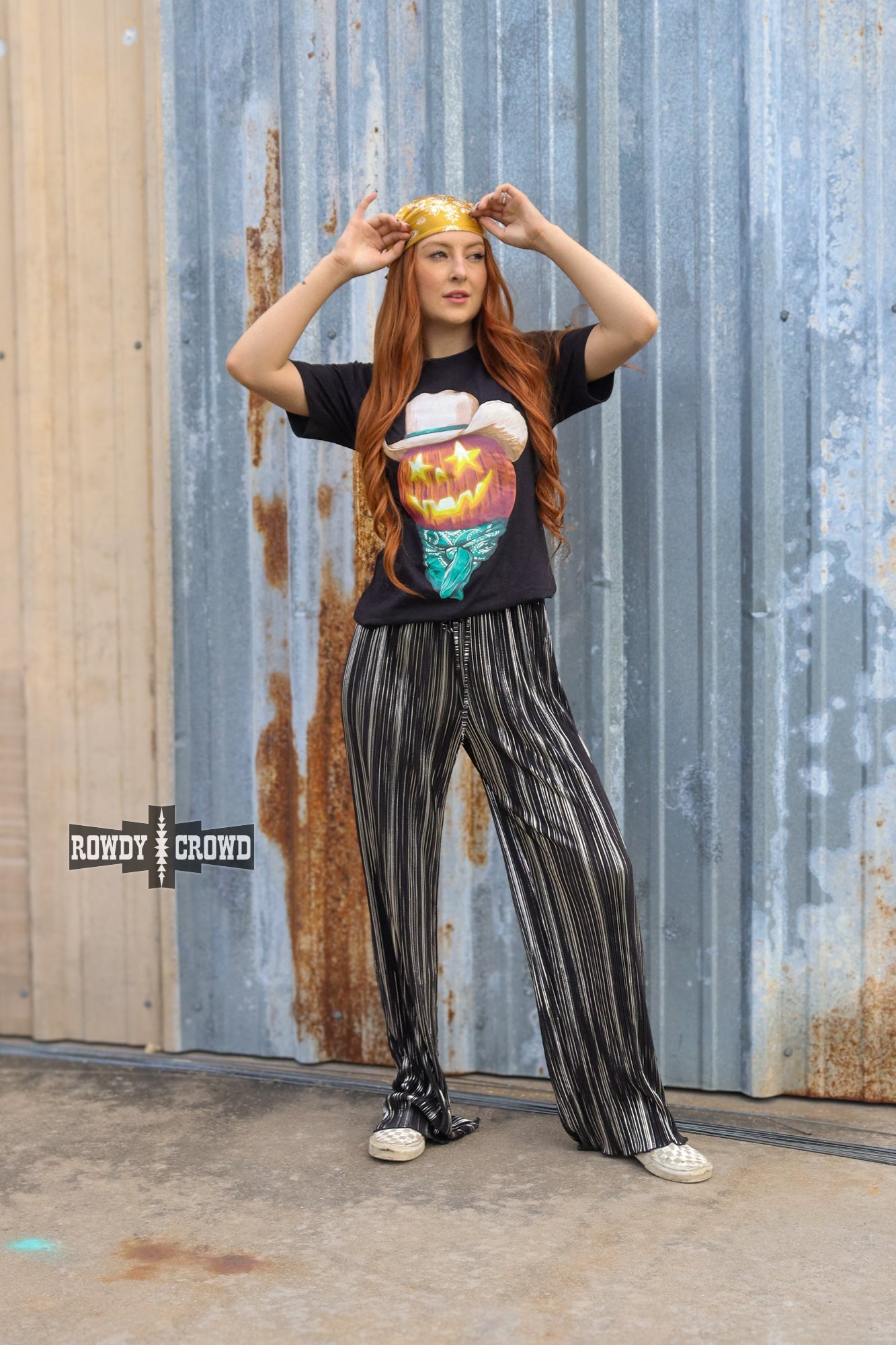 Person wearing a graphic t-shirt and Rowdy Crowd Ruffled Cup wide leg striped pants 
