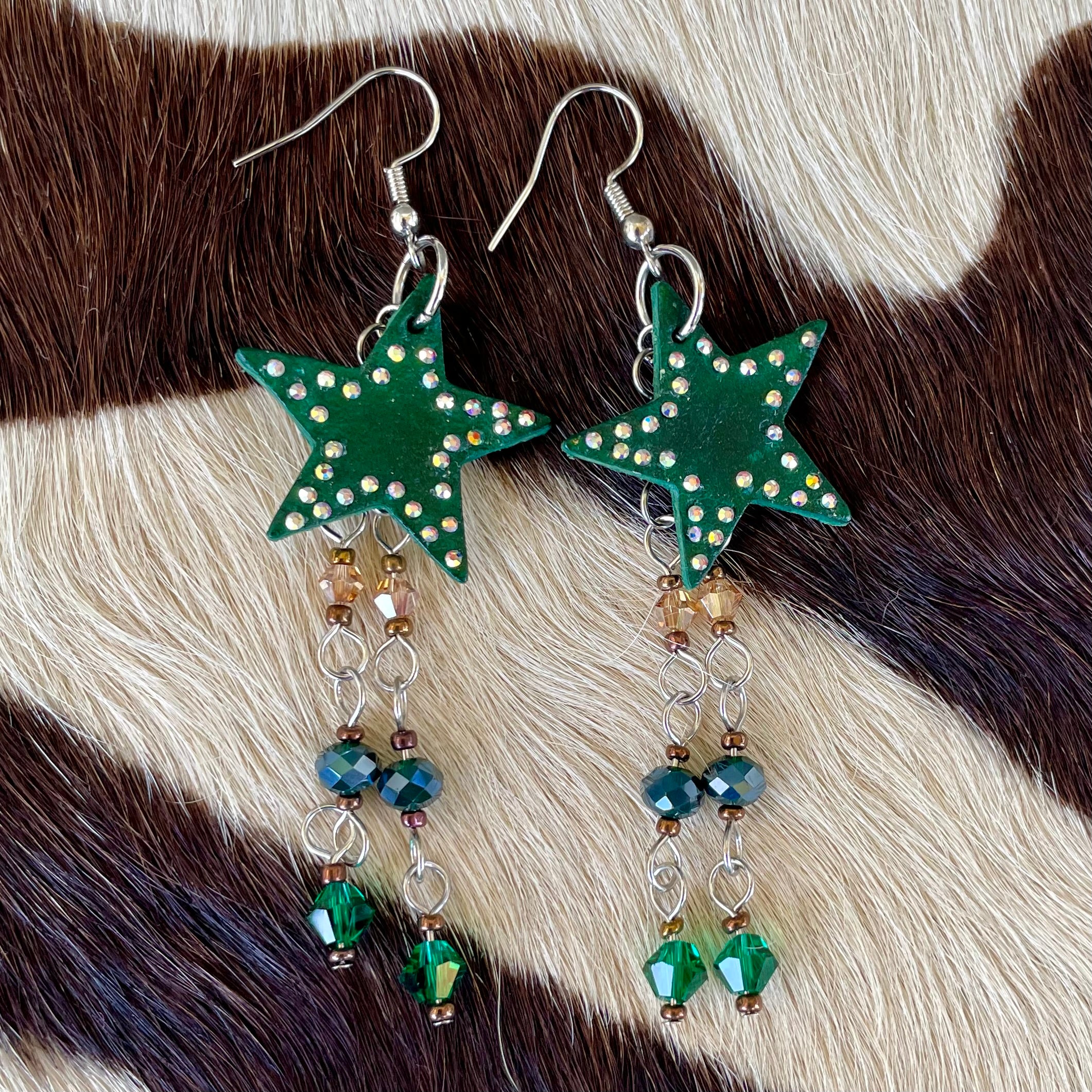 Hunter green leather star earrings with multicolored hanging beads and adorned with rhinestones, handmade western jewelry for cowgirls and nature-inspired fashion lovers.