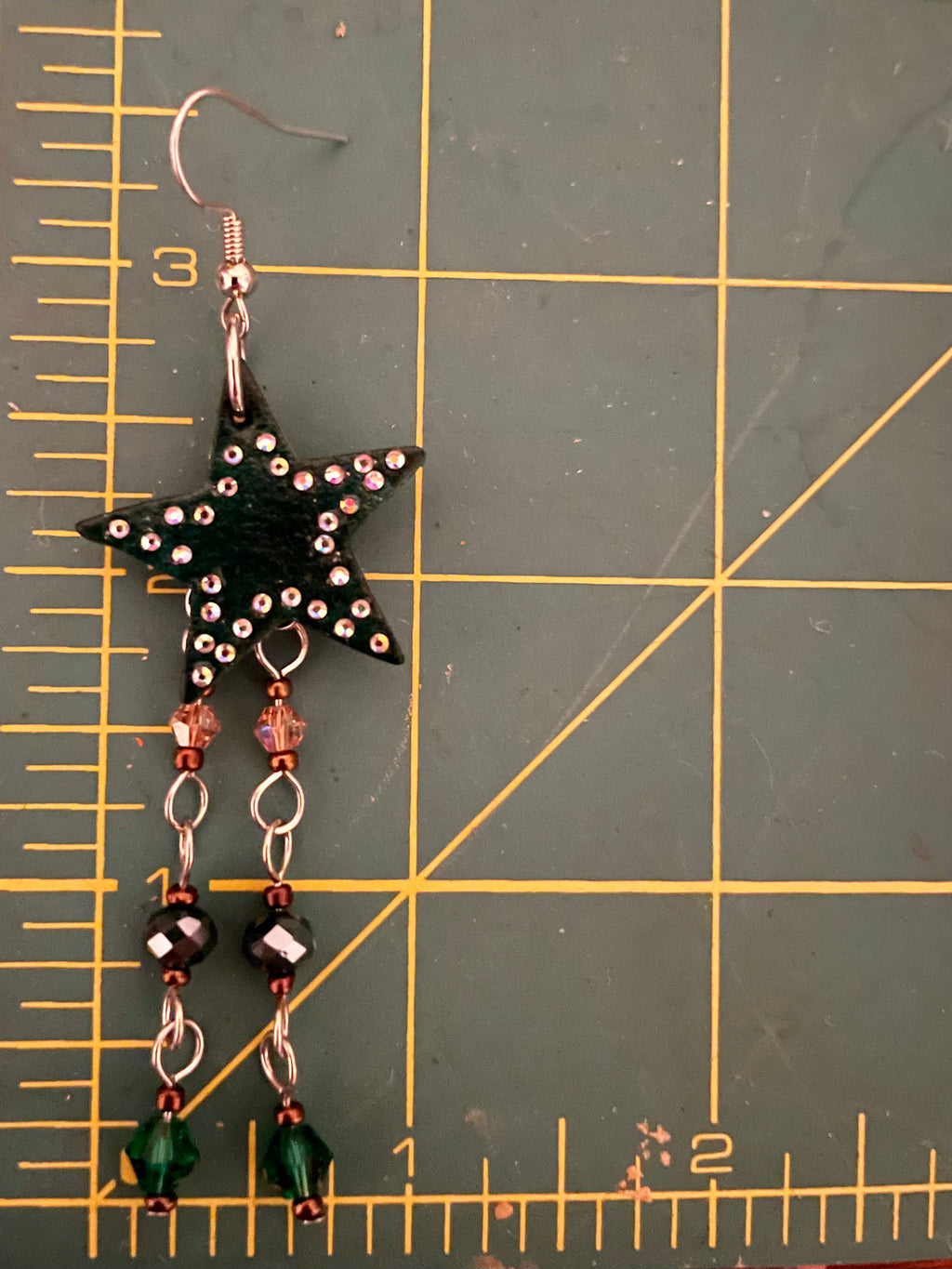 Hunter green leather star earrings with multicolored hanging beads and adorned with rhinestones, handmade western jewelry for cowgirls and nature-inspired fashion lovers.