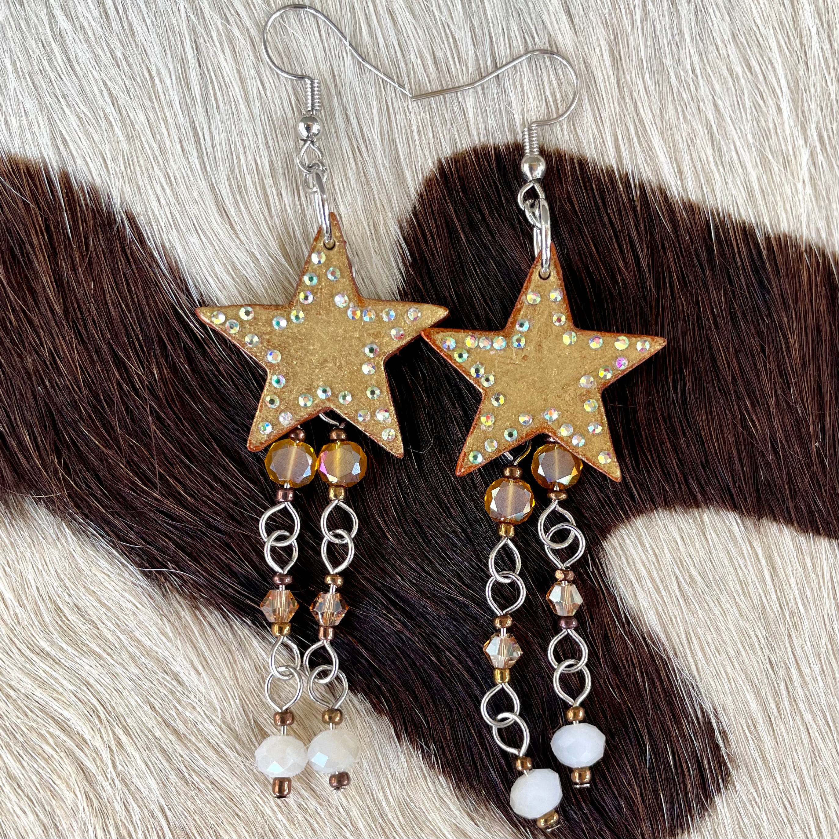 Golden leather star earrings with butterscotch hanging beads and rhinestone accents handmade western jewelry for cowgirls and rodeo fashion lovers