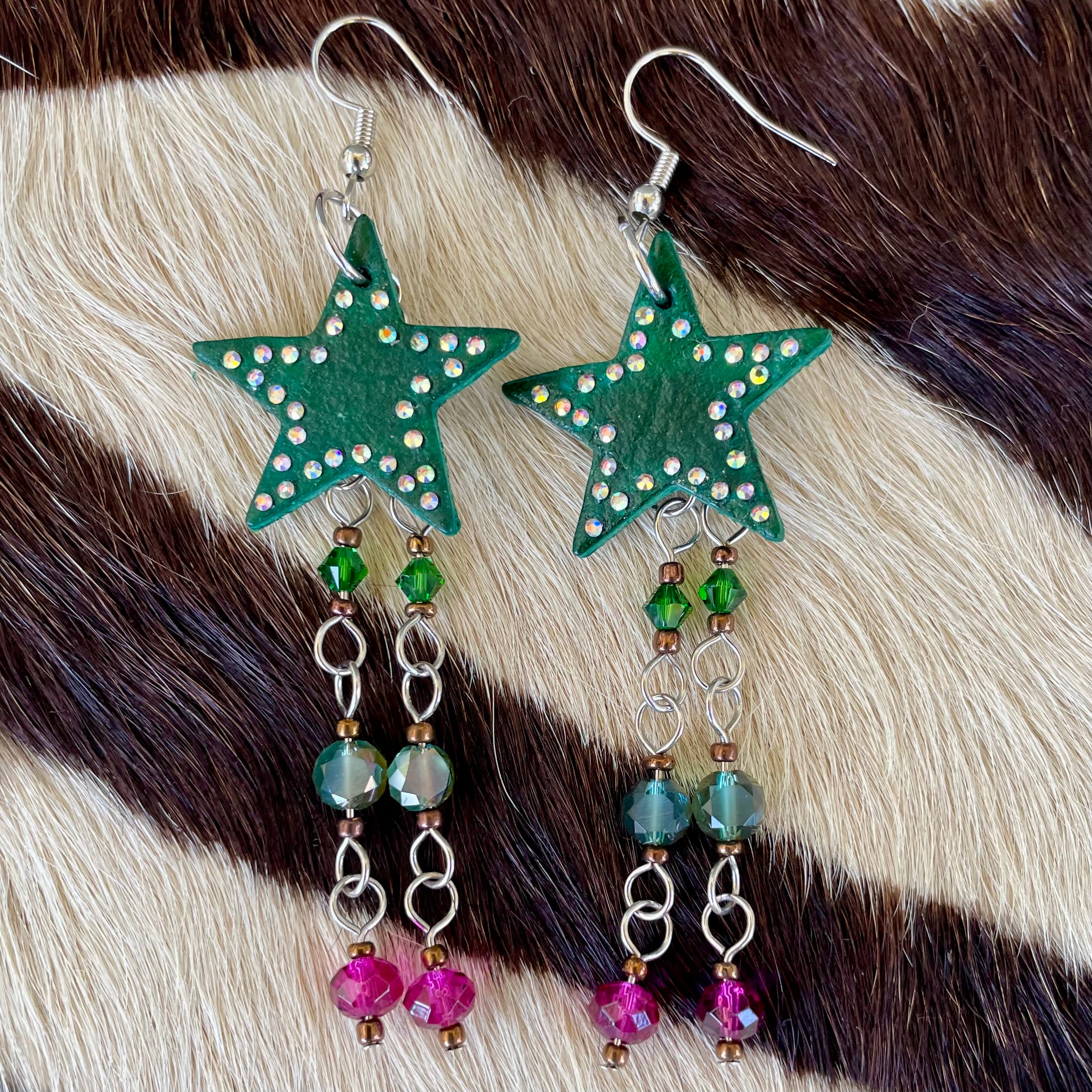Hunter green leather star earrings with multicolored hanging beads and adorned with rhinestones, handmade western jewelry for cowgirls and nature-inspired fashion lovers.