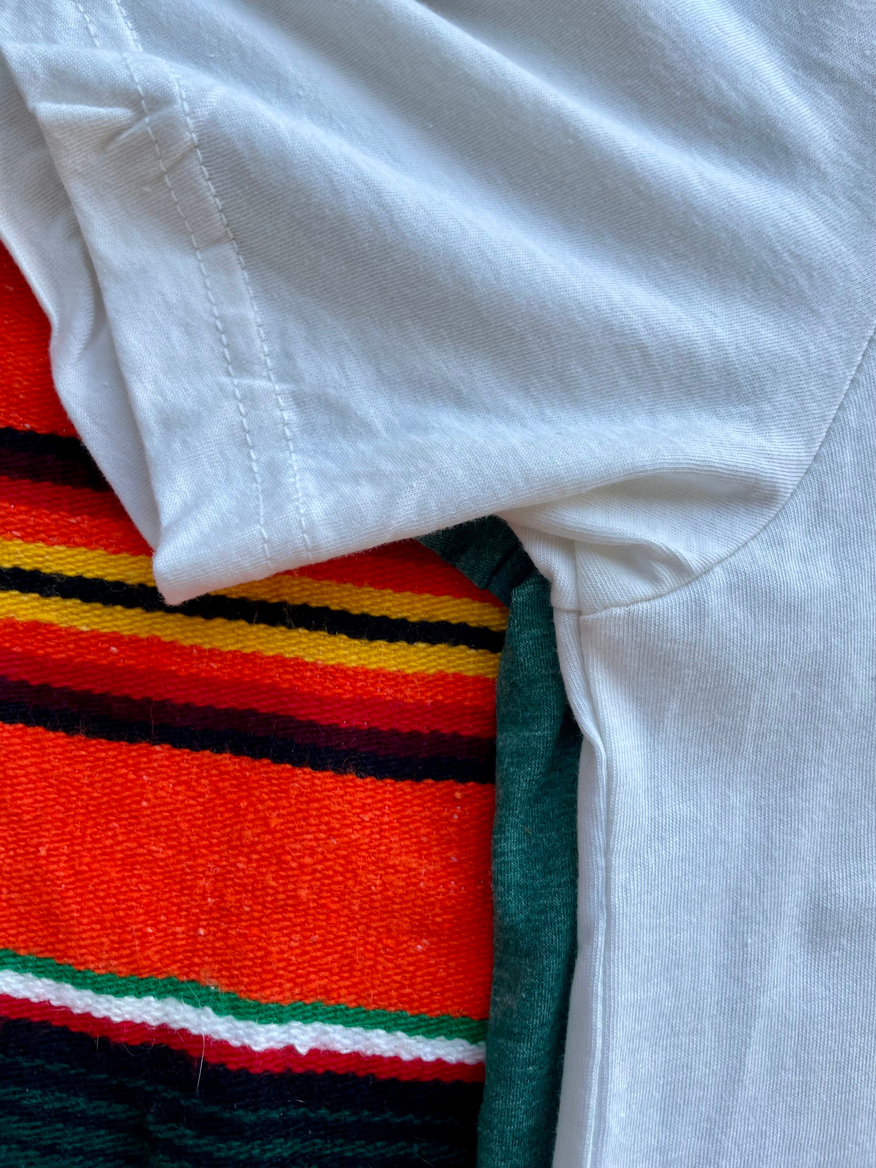 Close-up of a white shirt over a colorful striped fabric background