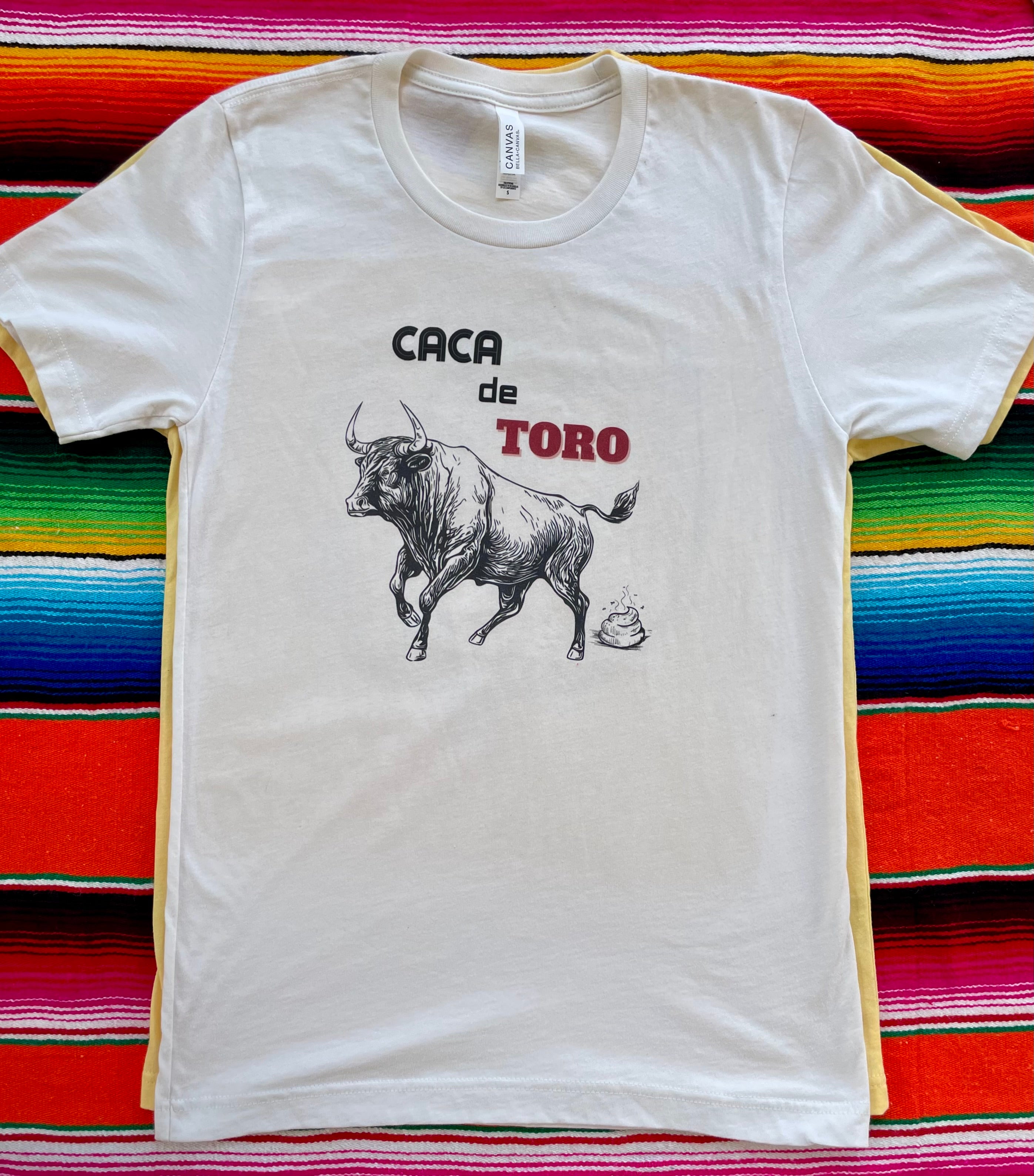 Yellow t-shirt with a graphic design of a woman in a hat and skirt, cactus, and sun on a colorful striped background.