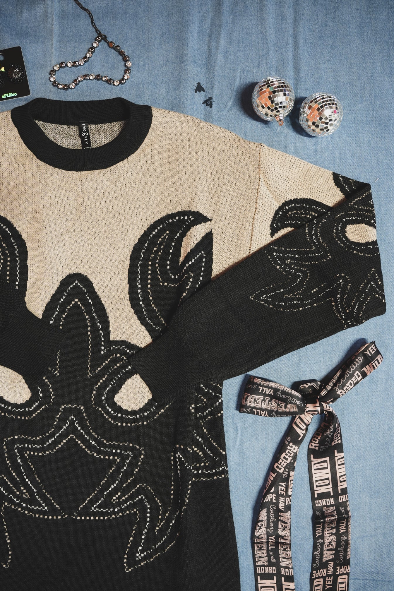 Black and beige patterned western style boot print dress with a cowboy hat