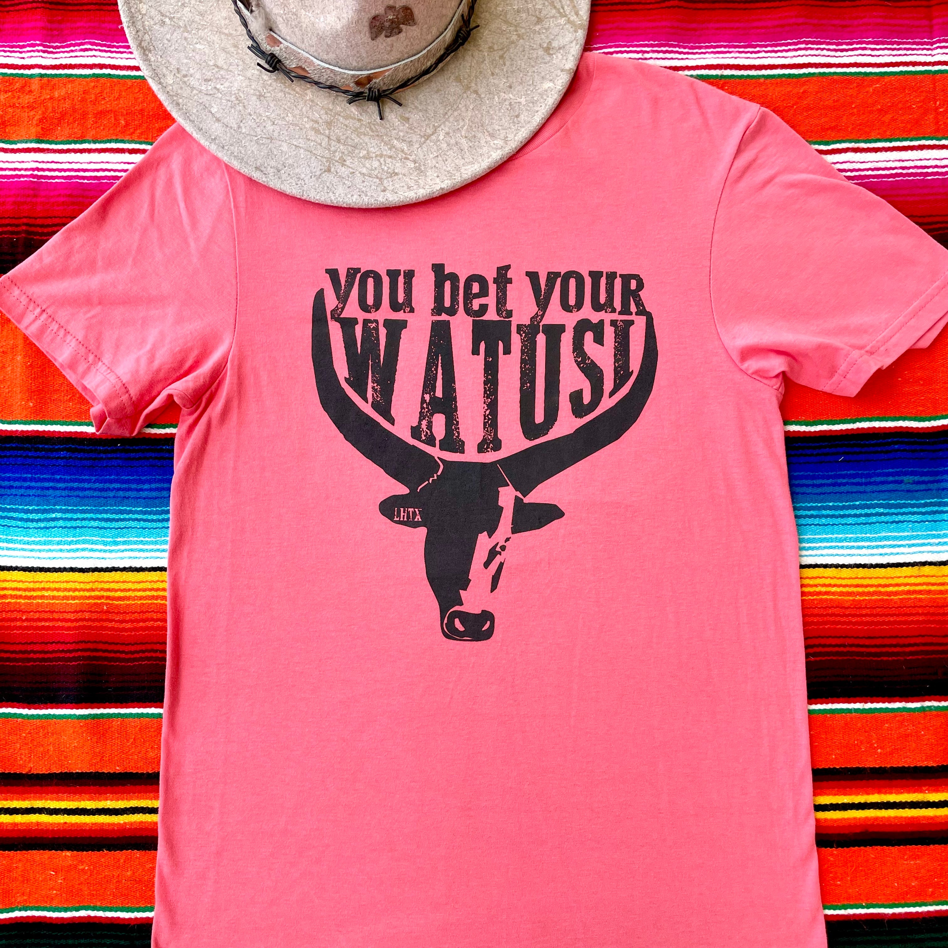Pink cowgirl graphic t-shirt with "You Bet Your Watusi" slogan and illustrated by LHTX with a hand drawn Watusi bullhead western fashion apparel by the Bucktooth Horse