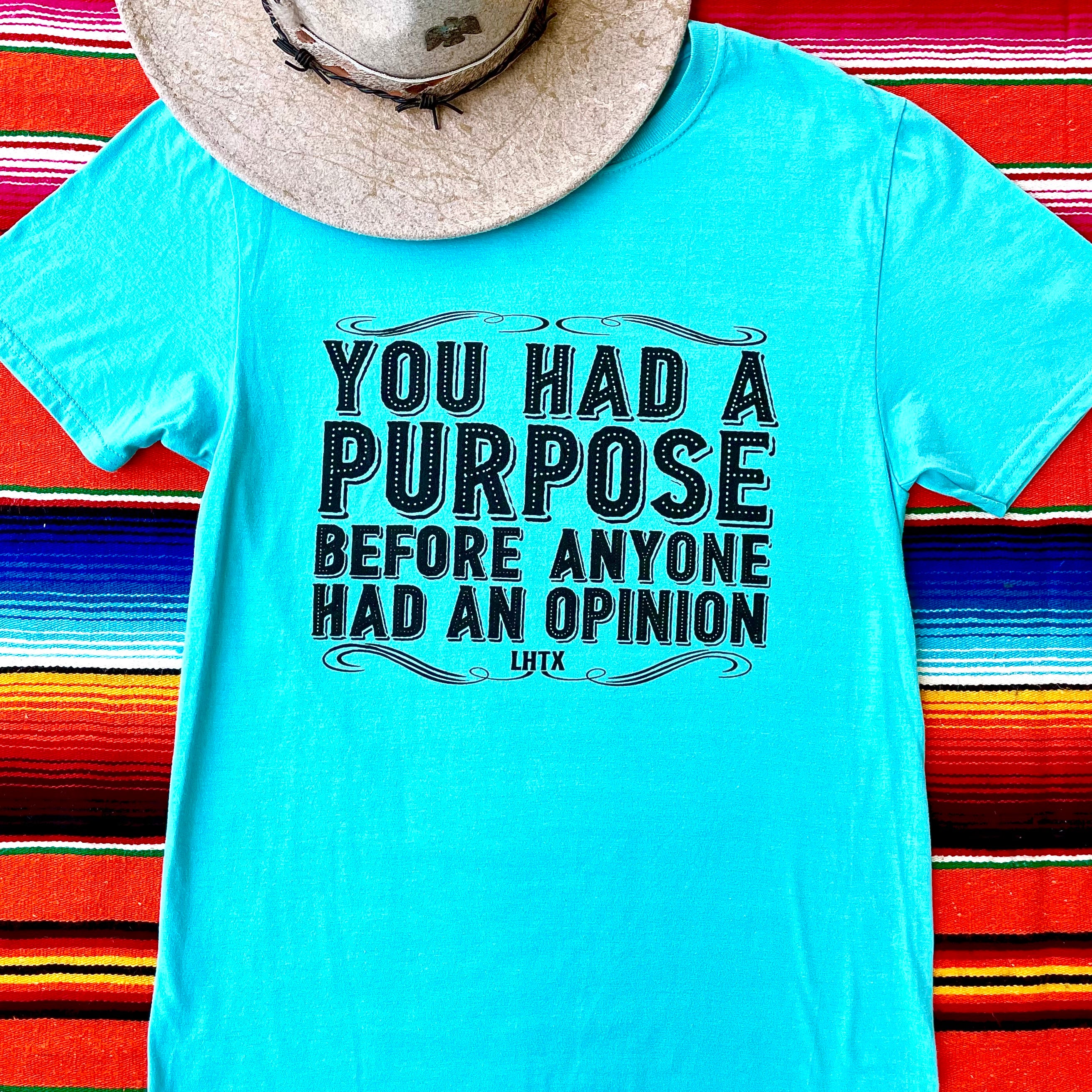 Inspirational unisex graphic t-shirt in turquoise with bold motivational quote on colorful background