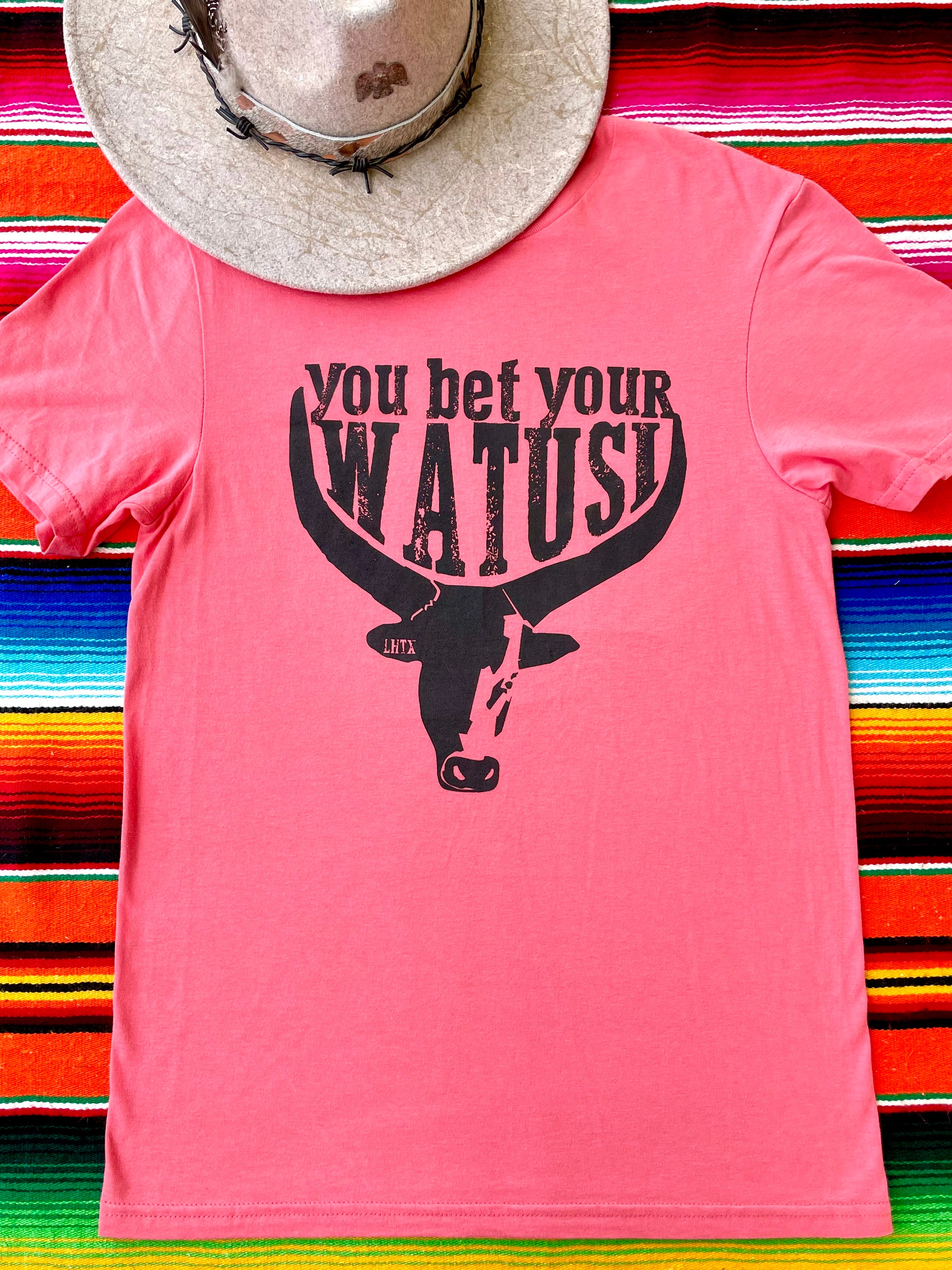 Pink cowgirl graphic t-shirt with "You Bet Your Watusi" slogan and illustrated by LHTX with a hand drawn Watusi bullhead western fashion apparel by the Bucktooth Horse
