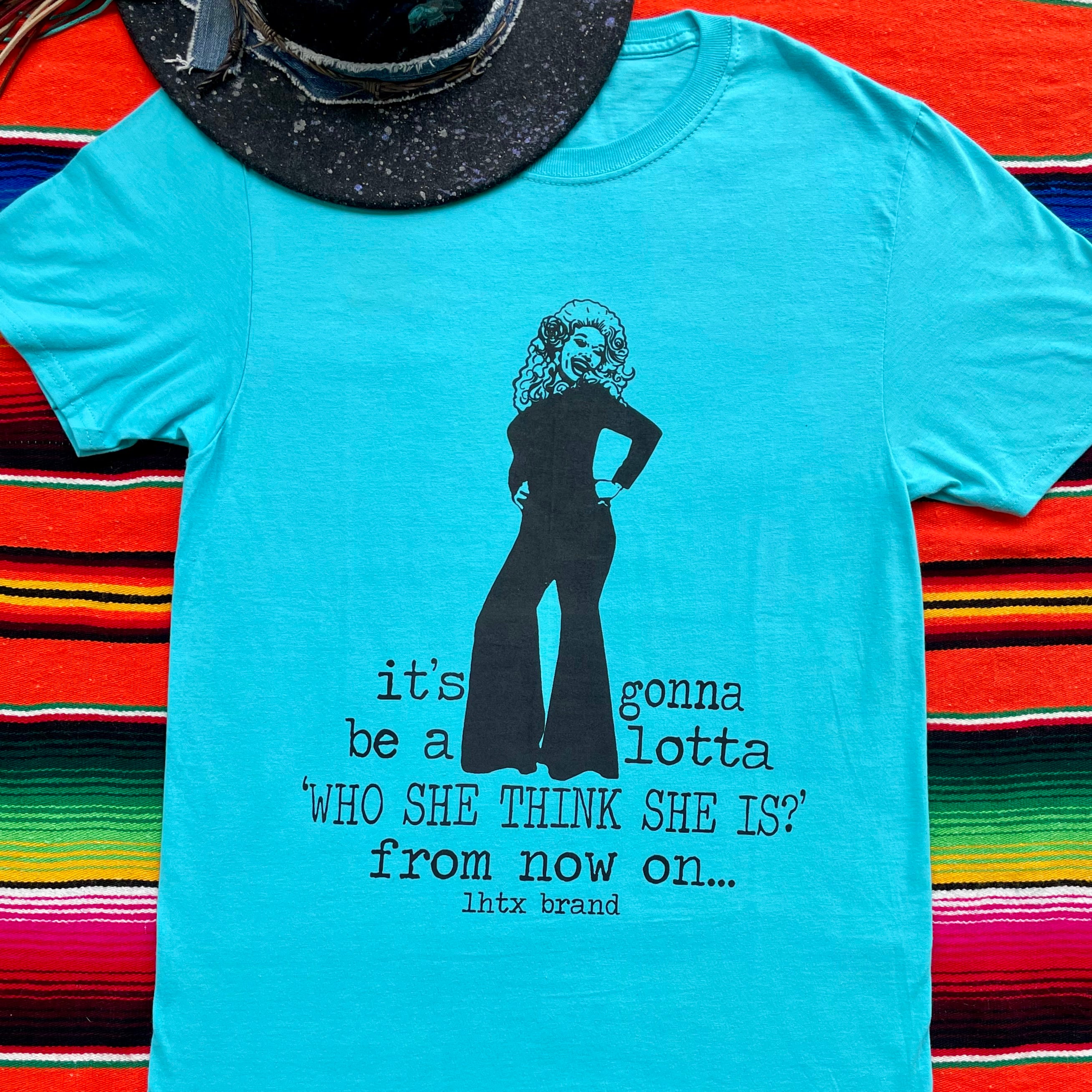 Blue t-shirt with a graphic and text on a colorful striped background