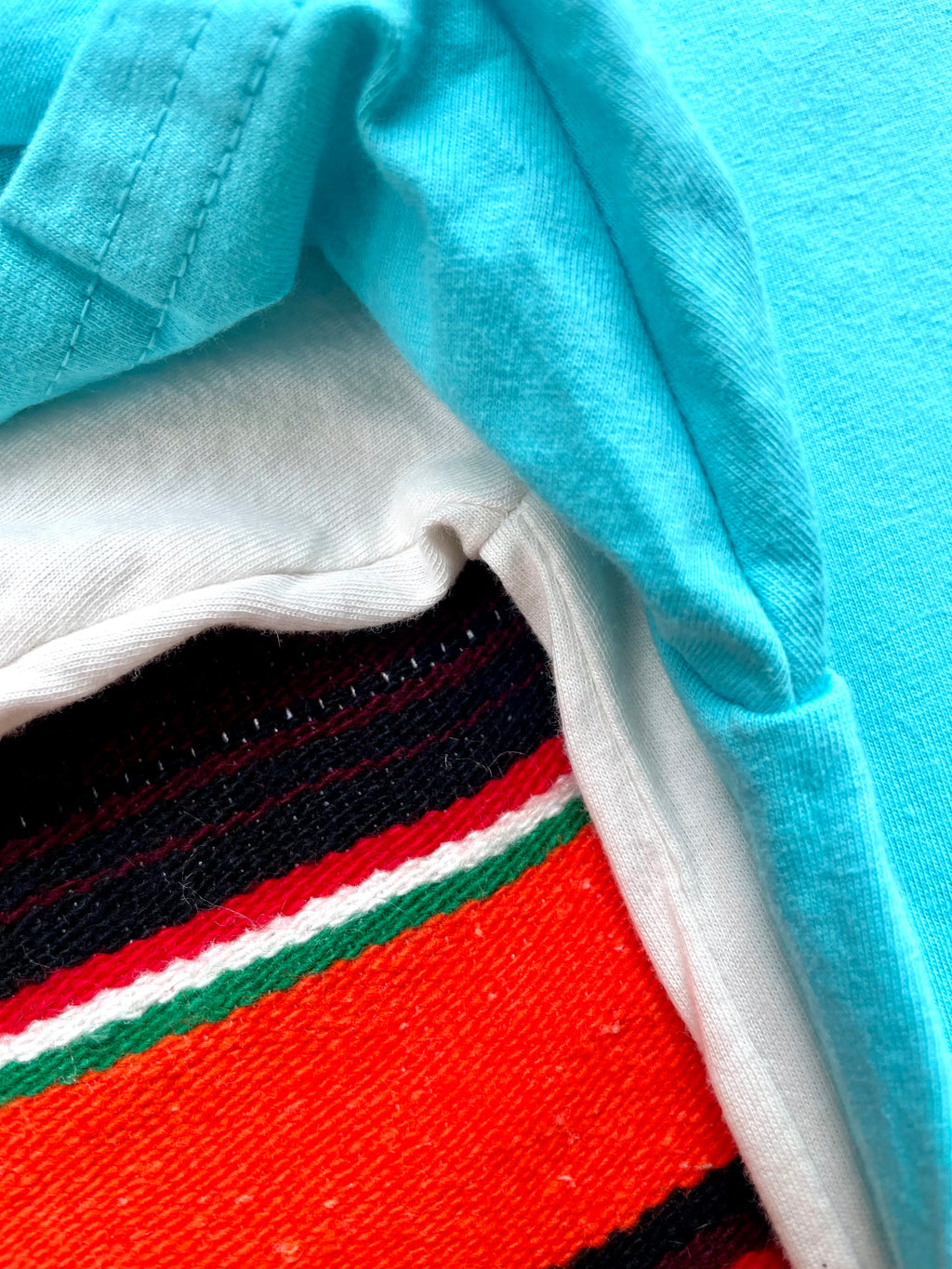 Close-up of a fabric with a striped pattern on a blue background