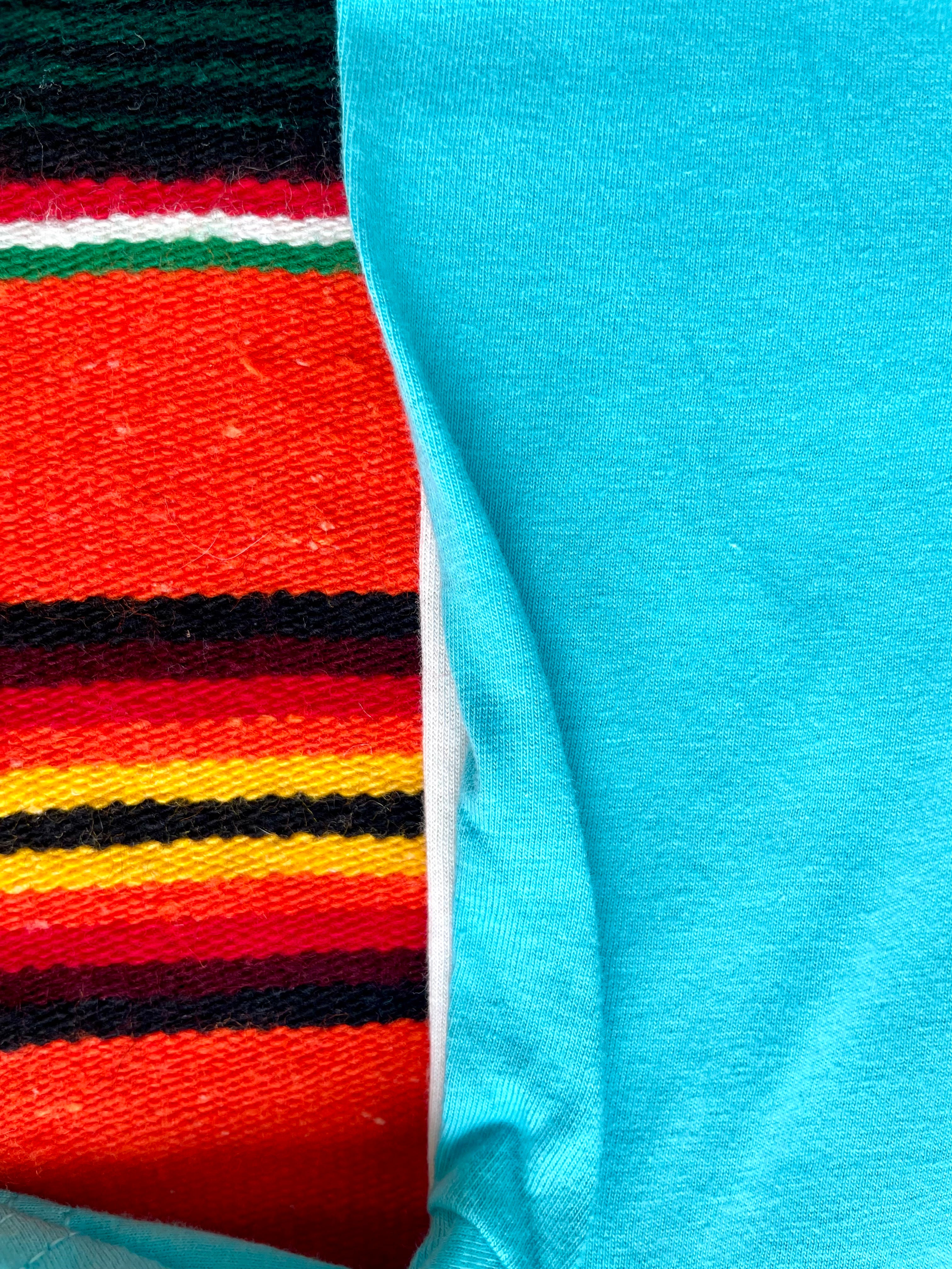 Close-up of colorful striped fabric and turquoise fabric