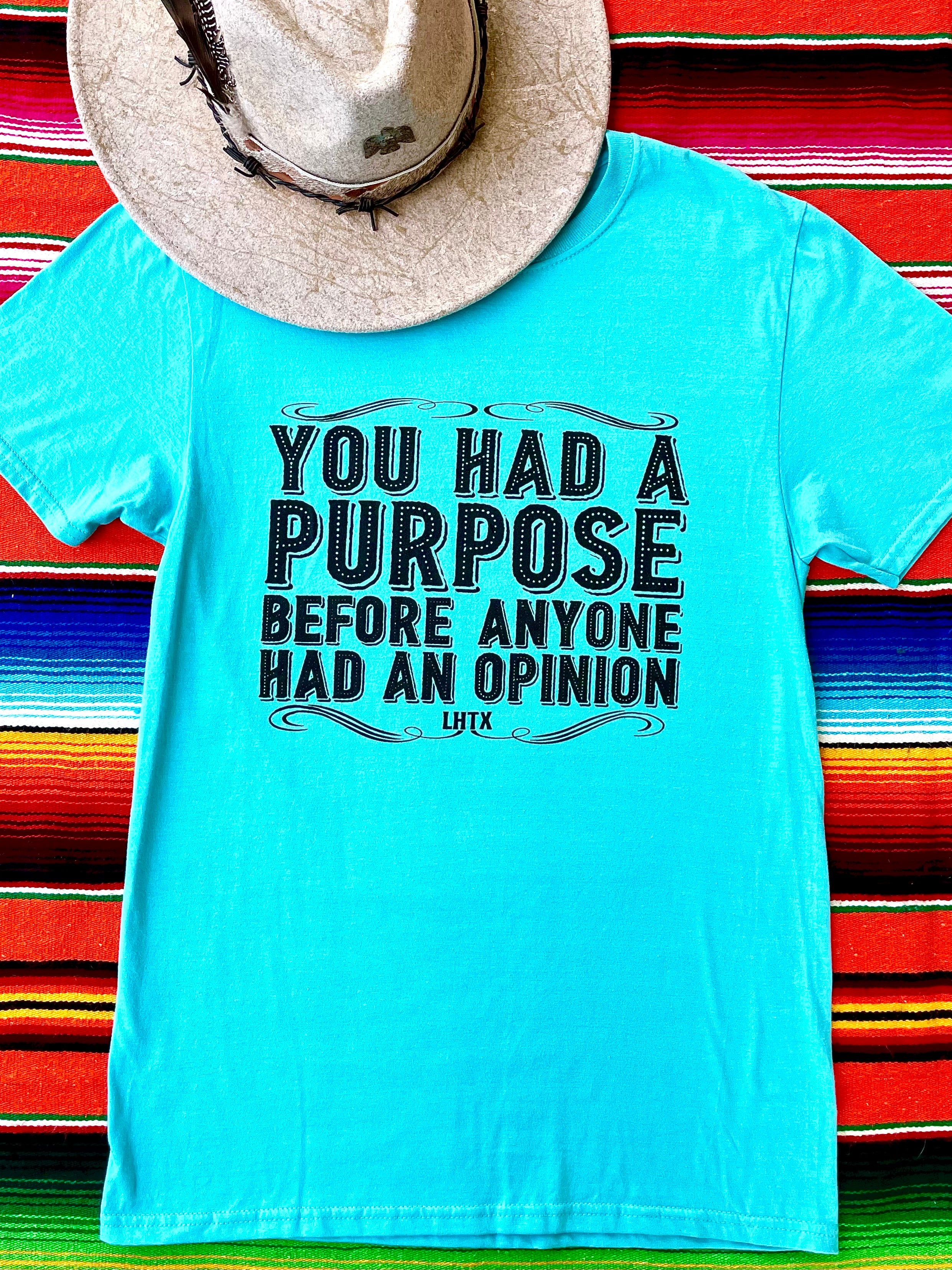 Inspirational unisex graphic t-shirt in turquoise with bold motivational quote on colorful background